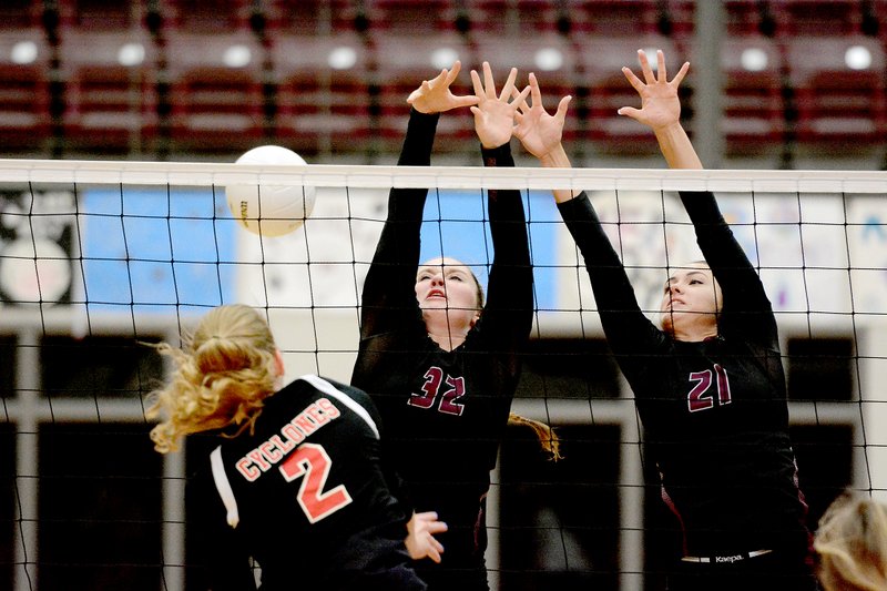 Bud Sullins/Special to Siloam Sunday Russellville senior Ashton Sitkowski, left, scores a kill Thursday night as Siloam Springs senior Haley Stewart, middle, and junior Madison Cooper attempt to block the hit. The Lady Cyclones won the 7A/6A-Central match 3-1.