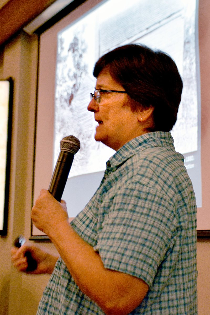 Janelle Jessen/Siloam Sunday Susan Young, of the Shiloh Museum of Ozark History, told diners attending Meat, Meal and Molasses on Thursday evening about the history of traditional ingredients and showed slides of local photos from the past.