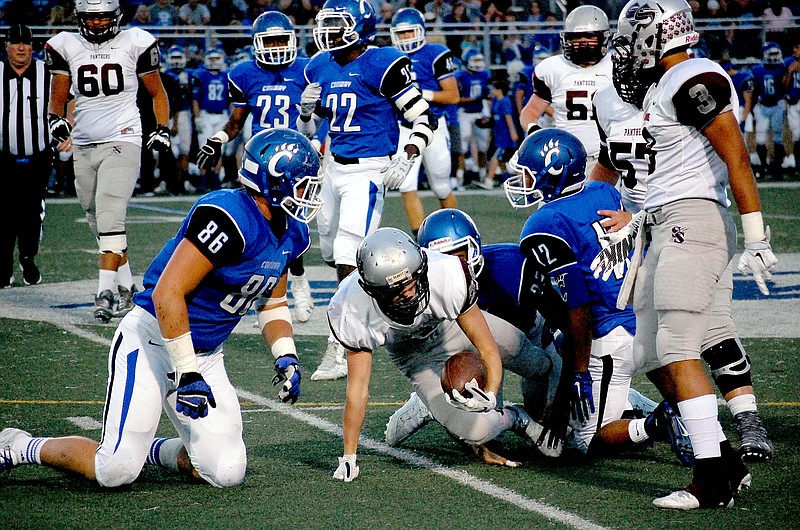 Graham Thomas/Siloam Sunday Siloam Springs running back Ricky Hughes fights for extra yardage in the Panthers&#8217; 38-24 loss at Conway on Friday.