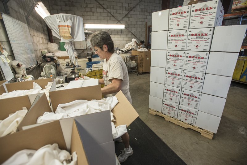 NWA Democrat-Gazette/ANTHONY REYES  @NWATONYR Patsy Muller, with Northwest Rags, Inc., boxes rags Wednesday at their facility in Springdale. The company ships used clothing all over the world, and has a line of industrial rags, Ozark Recycled Wiping Rags.