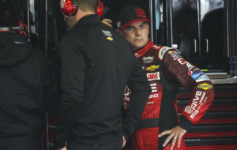 Driver Jeff Gordon waits while his car is worked on during practice for the NASCAR Sprint Cup series auto race at New Hampshire Motor Speedway, Loudon, N.H., Friday, Sept. 25, 2015