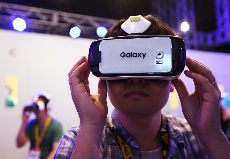 An attendee tries a video game on a Samsung Electronics Co. Galaxy Gear Virtual-Reality headset at the Tokyo Game Show in Chiba, Japan, earlier this month.