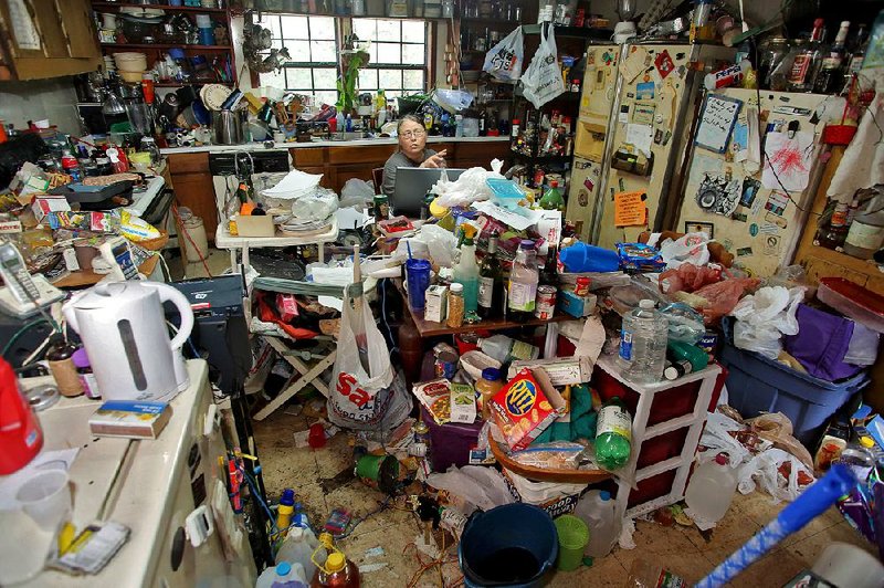 Melinda LaFevers sits by her laptop in the kitchen of her home in Searcy. In an effort to understand her hoarding, she blogs, posts on Facebook and has published a book, Meditations of a Hoarder (Just Cause, 2015).
