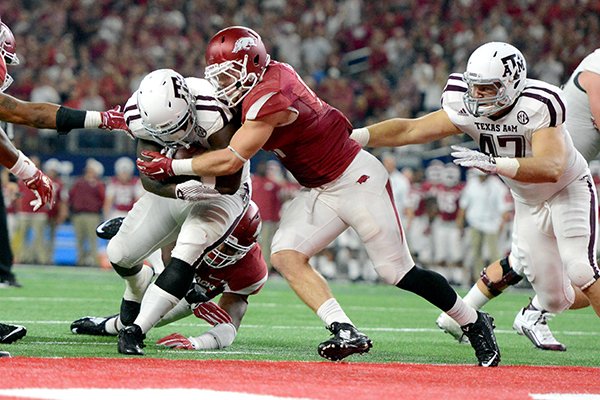 Arkansas' Brooks Ellis (51) meets Texas A&M's Tra Carson (5) at the goal line as he scores a touchdown during the fourth quarter of an NCAA college football game Saturday, Sept. 26, 2015, in Arlington, Texas. Texas A&M won 28-21 in overtime. (Sam Craft/The Bryan-College Station Eagle)