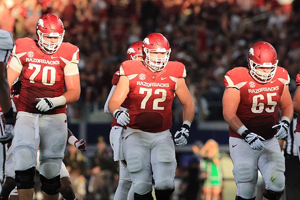 Arkansas linemen Dan Skipper (70), Frank Ragnow (72) and Mitch Smothers (65) line up during a game against Texas A&M on Saturday, Sept. 26, 2015, at AT&T Stadium in Arlington, Texas. 