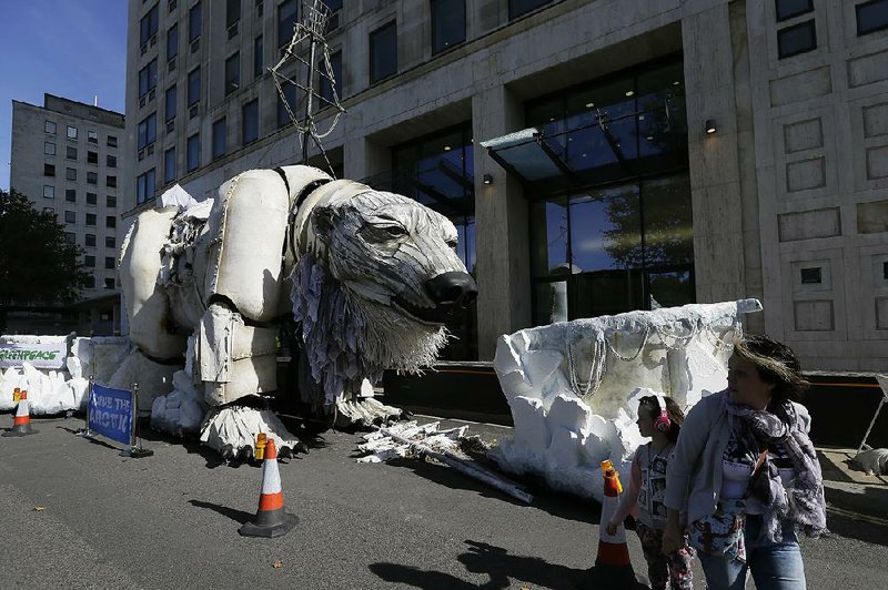 A giant polar bear model, placed in protest by members of Greenpeace, stands outside the Shell Building in London on Monday.
