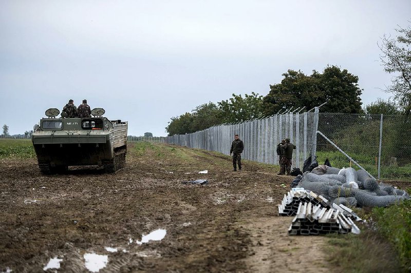 Hungarian soldiers patrol in an amphibious transport vehicle near the border crossing between Hungary and Croatia at Beremend, Hungary, on Monday.