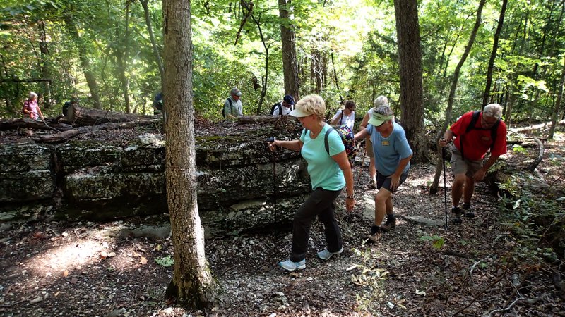 Hikers work their way through rock formations Sept. 16 while exploring Lost Ridge Trail at Lake Leatherwood in Eureka Springs. The remote route is part of the trail network at Lake Leatherwood City Park, which features about 21 miles of trail for hiking and off-road cycling.