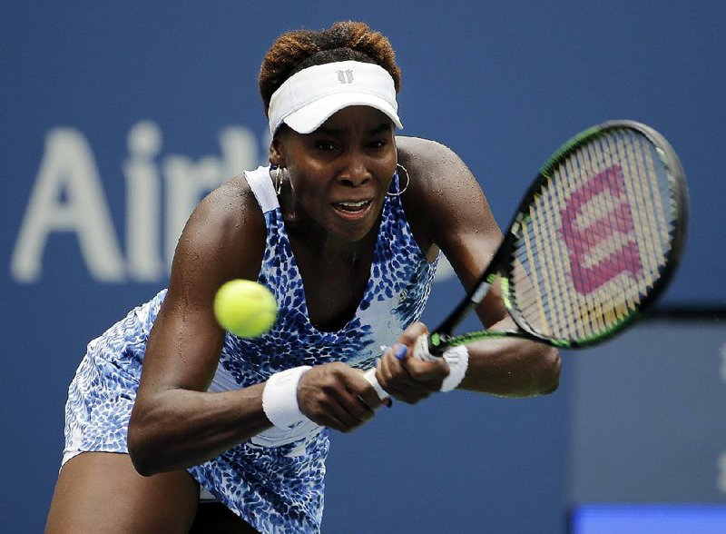 Venus Williams, of the United States, returns a shot to Belinda Bencic, of Switzerland, during the third round of the U.S. Open tennis tournament, Friday, Sept. 4, 2015, in New York. 