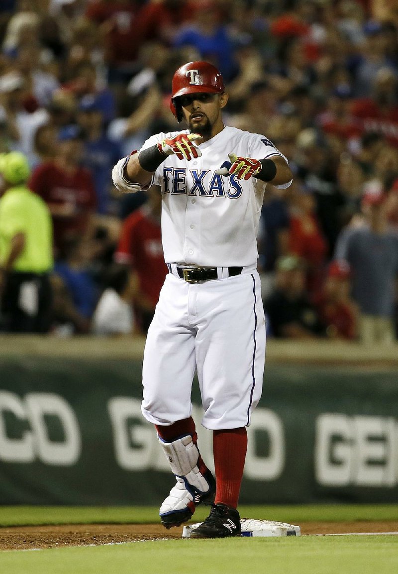 Texas infielder Roughned Odor celebrates after a first-inning RBI triple in the Rangers’ 7-6 victory over Detroit.