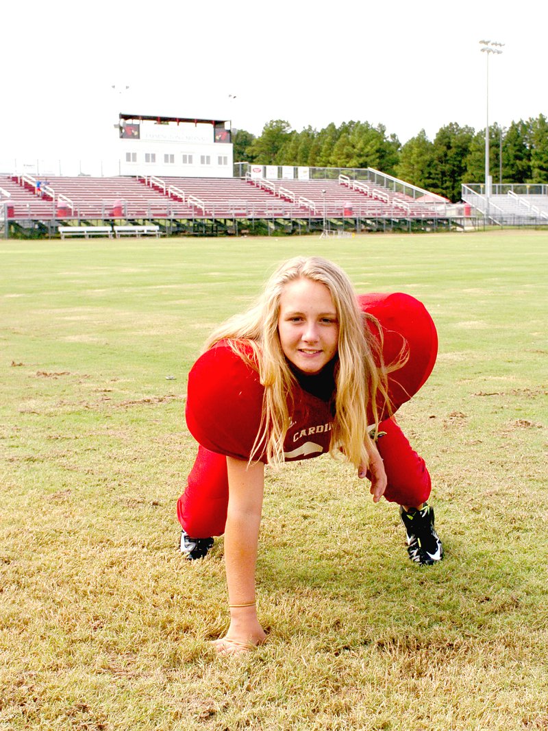 MARK HUMPHREY ENTERPRISE-LEADER Seventh-grader Erica Stotler demonstrates a lineman&#8217;s stance as she learns the game of football at Farmington&#8217;s Allen Holland Field. Erica is carrying on the legacy of her father, Eric, who played quarterback for the Cardinals in high school.