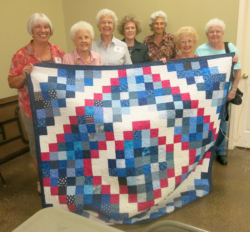 Photo by Susan Holland The Gravette Historical Museum and members of the PieceMakers Quilt Club will host a quilt show at the Gravette Civic Center Saturday, Oct. 10. Here members of the club display a red, white and blue quilt made by Betty Howard for the Quilts of Valor program, which provides quilts for service members and veterans. Pictured are Janice Waters (left), Maxine Paulson, Lou Romine, Cleta Whitman, Rowena Meek, Betty Howard and Kay Buckminster.