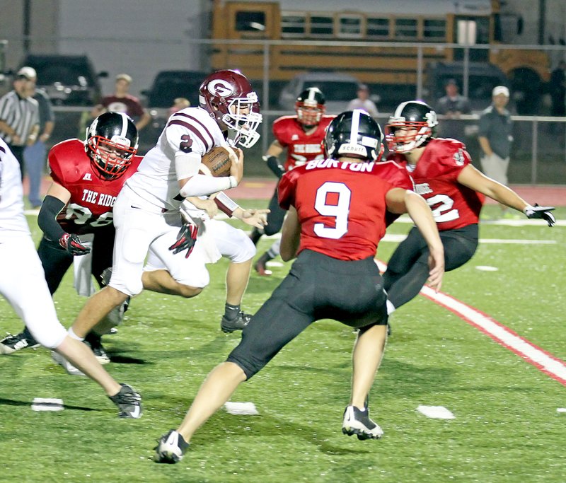 Photo by Russ Wilson CJ Taylor, Gentry senior, runs the ball through a host of Pea Ridge defenders during play between the two teams at Pea Ridge on Friday.