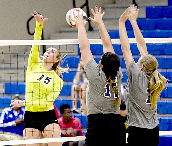 Photo courtesy of JBU Sports Information John Brown University senior Melissa Bakke, left, smacks one of her 11 kills against Southwestern Assemblies of God on Saturday.