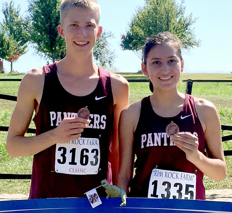 Photo submitted Siloam Springs runners Elliott Pearson, left, and Jasmine Guillen both earned medals at the University of Kansas Rim Rock Classic on Saturday.