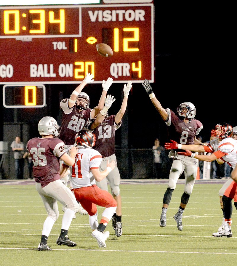 Bud Sullins/Special to the Herald-Leader Siloam Springs defenders Lance Slaton (No. 20), Cade Miller (No. 13) and Marquan Sorrells (No. 8) look to bat down a pass in the final seconds against Claremore, Okla., on Sept. 18. The Panthers host Alma at 7 p.m. Friday at Panther Stadium.