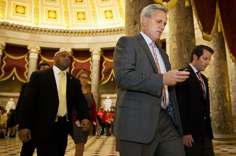 House Majority Leader Kevin McCarthy (foreground), R-Calif., a candidate to succeed House Speaker John Boehner, heads to the House chambers Wednesday for debate on the spending bill. 
