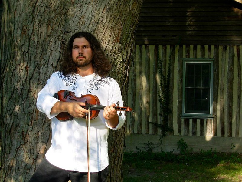 Fiddler Dennis Stroughmatt performs Friday at the Ozark Folk Center.
