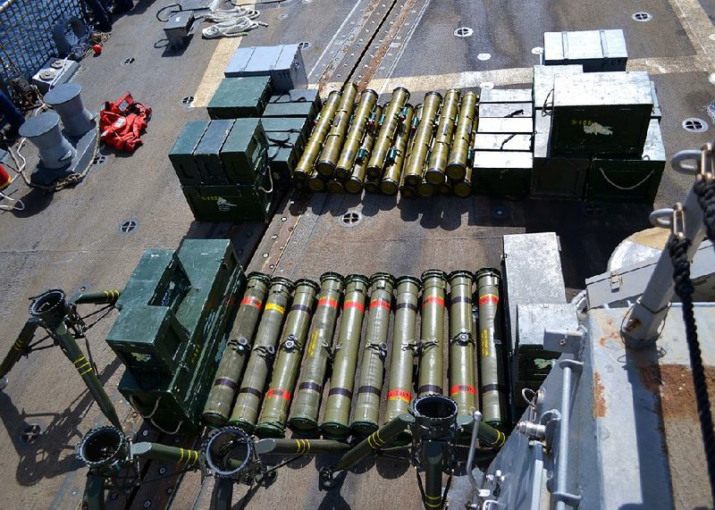 A photo released Wednesday by the U.S. Navy shows on the deck of the USS Forrest Sherman weapons and equipment confi scated from a ship intercepted last week off the Arabian Peninsula. 