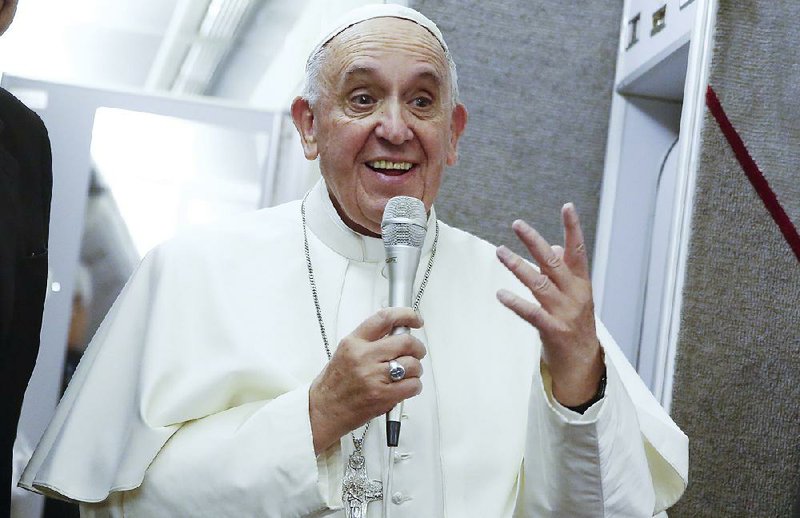 Pope Francis talks to journalists during a press conference he held while en route to Italy, Monday, Sept. 28, 2015.  