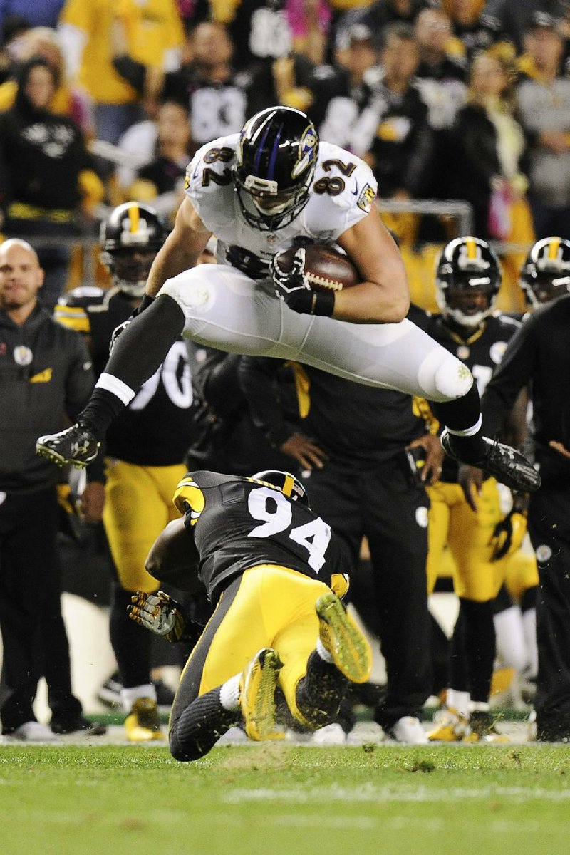 Baltimore tight end Nick Boyle (82) leaps over Pittsburgh linebacker Lawrence Timmons during the third quarter of Thursday night’s game. The Steelers missed two fi eld goals in the fi nal four minutes of the fourth quarter, which allowed the Ravens to come back and win their fi rst game of the season on Justin Tucker’s 52-yard fi eld goal in overtime. The victory was Baltimore’s third in the past four meetings between the teams.