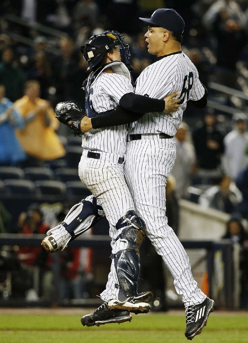 New York catcher John RyanMurphy (left) and relief pitcher Dellin Betances celebrate Thursday night after the Yankees clinched their first playoff berth since 2012 with a 4-1 victory over Boston. 