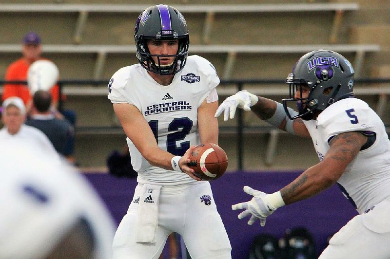 Central Arkansas quarterback Hayden Hildebrand (12) hands off to running back Dominique Thomas during last week’s 49-21 victory at Northwestern (La.) State. Hildebrand, who took over after Taylor Reed suffered a shoulder injury, is expected to start this week against Abilene Christian.