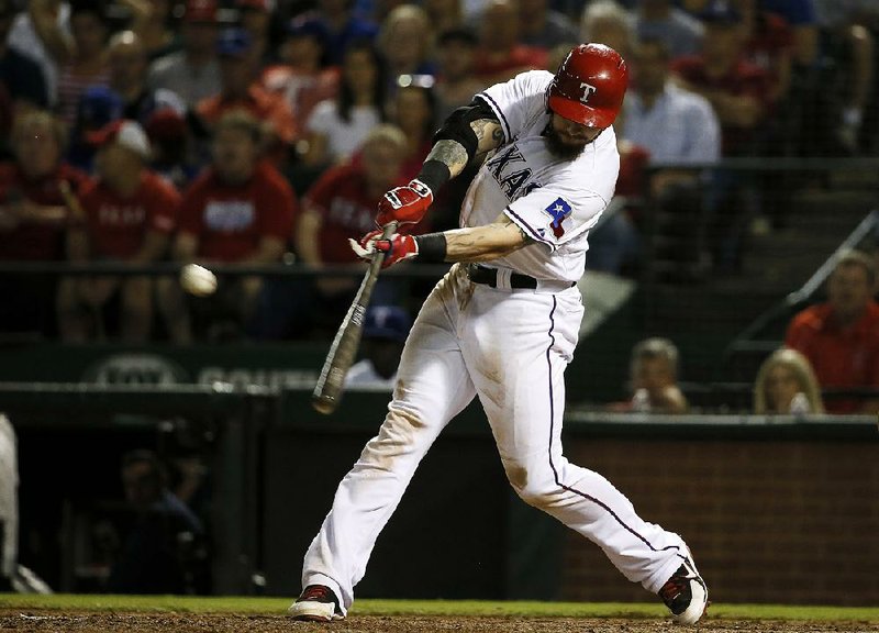 Texas outfielder Josh Hamilton hit a sacrifi ce fl y in the seventh inning Thursday to score Adrian Beltre in the Rangers’ 5-3 victory over the Los Angeles Angels, securing a playoff berth for the Rangers.
