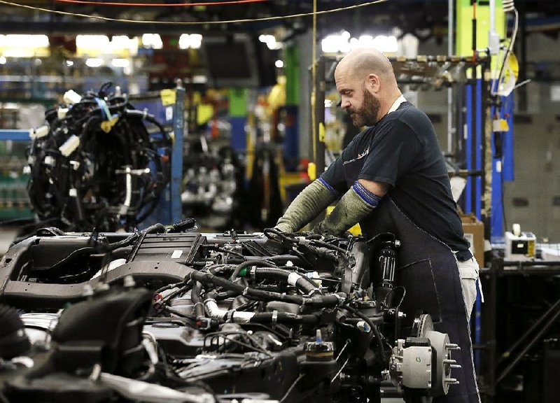 A General Motors employee works on the assembly line at a GM plant in Arlington, Texas, in July. Adjusted for seasonal trends, automakers sold 18.2 million vehicles in September, according to a report from Autodata Corp.