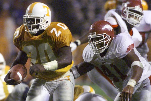 Tennessee's Travis Henry (left) breaks away from Arkansas' Melvin Bradley during the third quarter of the Volunteers' game against the Razorbacks on Saturday, Nov. 14, 1998, at Neyland Stadium in Knoxville, Tennessee.