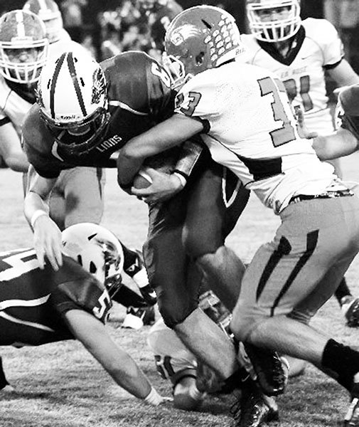 The Sentinel-Record/Corbet Deary JARRING JORDAN: Besides running for more than 300 yards and four touchdowns, Jordan Johnson (33) wraps up on Jessieville’s Nick Marshall as Glen Rose builds a 35-17 halftime lead Friday night at Phillips Field. Jessieville goes to Haskell Harmony Grove for a conference game next week, then plays consecutive home games against Episcopal Collegiate and Horatio.