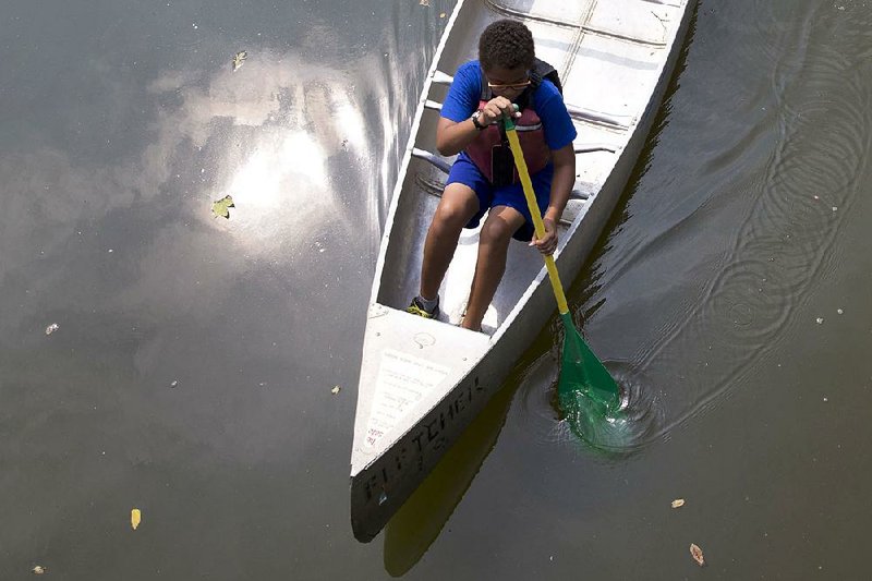 After launching from the Boathouse at Fletcher’s Cove, Matthew Grant of Washington paddles along the Chesapeake and Ohio Canal. 
