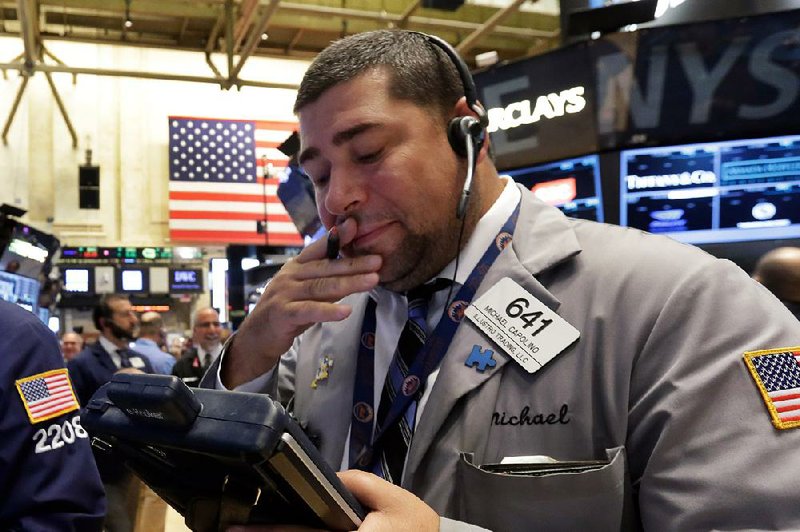 Trader Michael Capolino works Friday on the fl oor of the New York Stock Exchange.