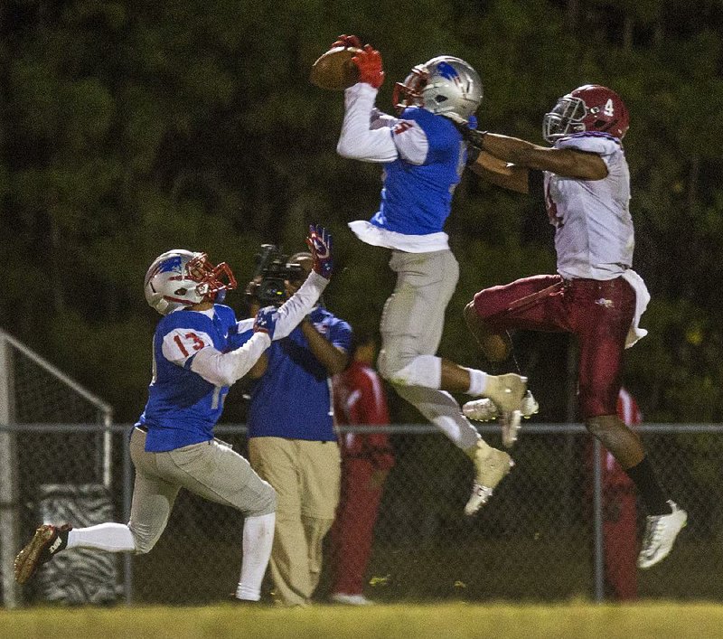 Little Rock Parkview’s Denzel McElroy grabs an interception in front of Pine Bluff’s David Beasley during Friday night’s game. See more photos from Friday night’s games at arkansasonline.com/galleries