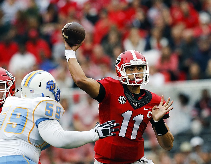 The Associated Press SHADES OF GREY: Georgia quarterback Greyson Lambert (11) throws under pressure from Southern defensive lineman Christopher Jones during the first half last week in Athens, Ga. Lambert has completed 76.5 percent of his passes for 733 yards and seven touchdowns, leading the Bulldogs to a 4-0 start. No. 8 Georgia hosts No. 13 Alabama, the reigning Southeastern Conference champion, at 2:30 p.m. today.