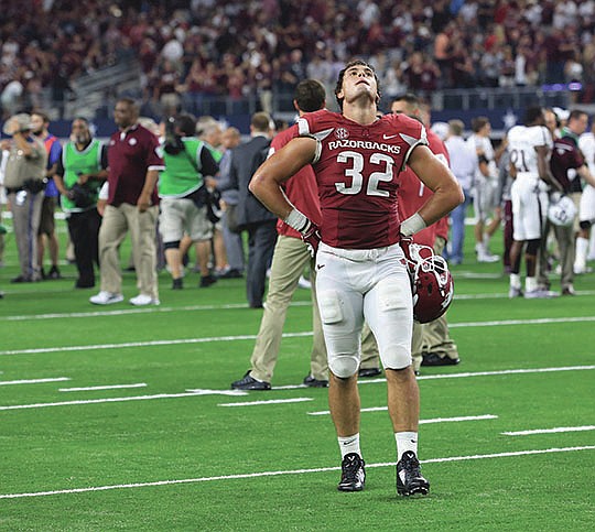 Arkansas Democrat-Gazette/Rick McFarland HOLDING OUT HOPE: Arkansas tight end Hunter Henry walks off the field after the Razorbacks fell to Texas A&M 28-21 in overtime last week in Arlington, Texas. The 1-3 Razorbacks move on to face Tennessee at 6 tonight in Knoxville, Tenn., on ESPN2 (Resort Channel 29), the Volunteers coming off a 28-27 loss at Florida after leading 27-14 in the fourth quarter. The Hogs led A&M 21-13 in the fourth before losing.