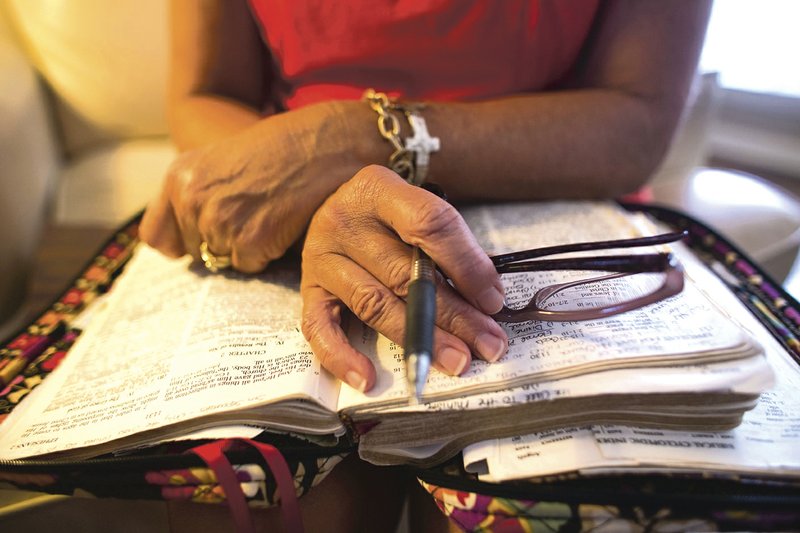 Mary McGee’s Bible sits on her lap while she prays with a Moms in Prayer group in North Little Rock. The group meets weekly to pray for their children and local schools. 
