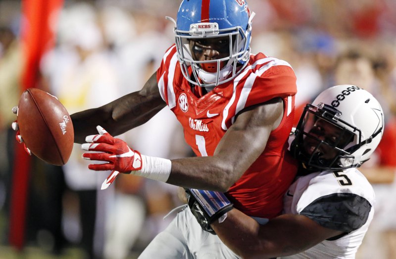 In this Sept. 26, 2015 file photo, Mississippi wide receiver Laquon Treadwell (1) is tackled by Vanderbilt cornerback Torren McGaster (5) during the first half of an NCAA college football game in Oxford, Miss. 