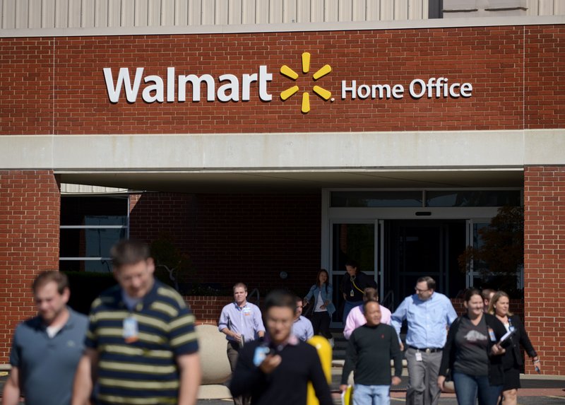 Wal-Mart Stores Inc. employees leave the home office in Bentonville in this October 2015 file photo.