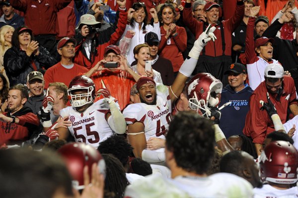 Arkansas players celebrate with their fans following their 24-20 victory over Tennessee in an NCAA college football game at Neyland Stadium in Knoxville, Tenn. on Saturday, Oct. 3, 2015. (Michael Patrick/Knoxville News Sentinel via AP)