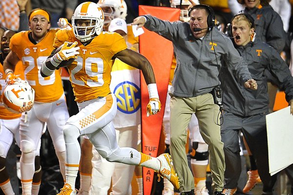 Tennessee head coach Butch Jones cheers on Evan Berry (29) as he returns a kickoff for a touchdown during the first half of an NCCAA College football game against Arkansas Saturday Oct. 3, 2015, in Knoxville, Tenn. (Larry McComack /The Tennessean via AP)