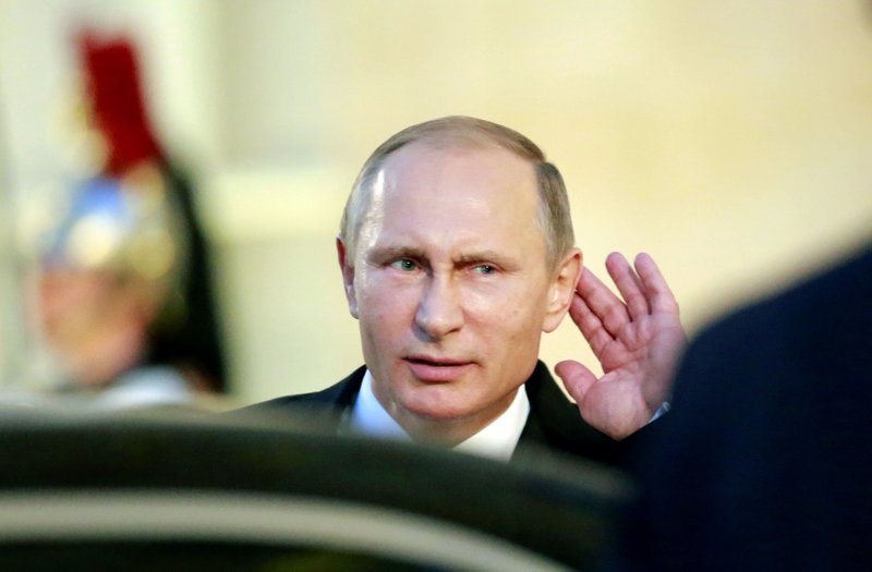 Russian President Vladimir Putin faces questions from journalists as he leaves Elysee Palace in Paris, where he met Friday with French and German leaders to discuss Syrian President Bashar Assad’s future.
