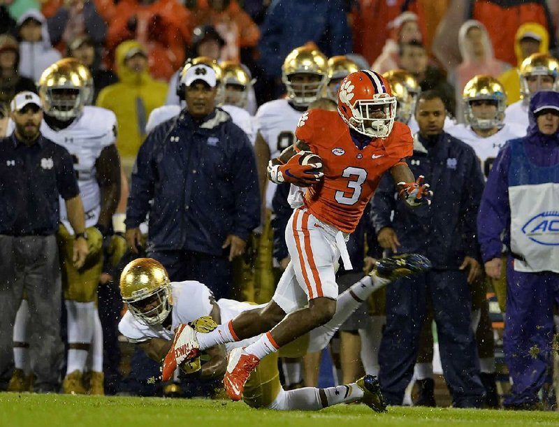 Clemson’s Artavis Scott (3) runs out of a tackle by Notre Dame’s Cole Luke during the first half of the No. 12 Tigers’ 24-22 victory over the No. 6 Fighting Irish on Saturday in Clemson, S.C.
