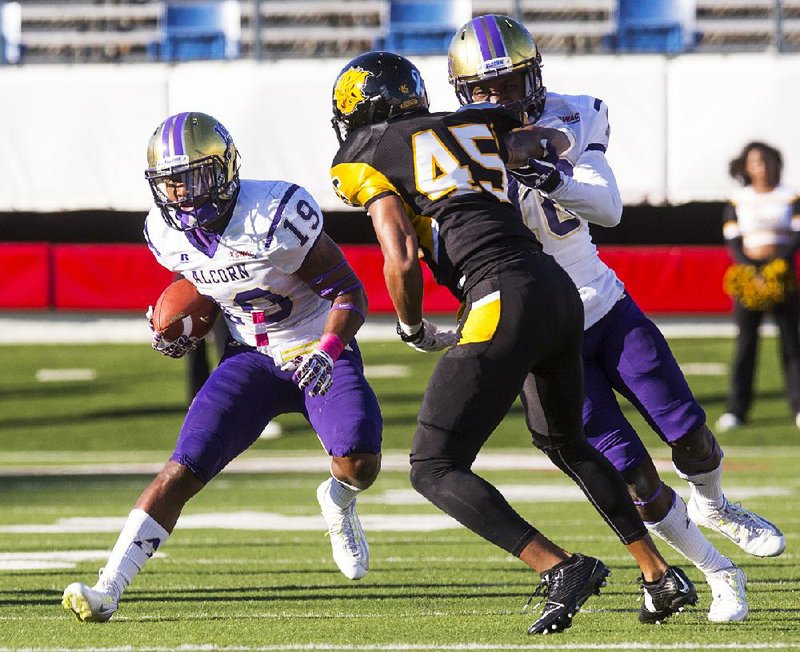 Alcorn State’s Anthony Williams Jr. looks for an opening as UAPB’s Sidney Austin closes in during Saturday’s game at War Memorial Stadium in Little Rock. The Braves jumped out to a 35-7 lead and cruised to their fourth consecutive victory.
