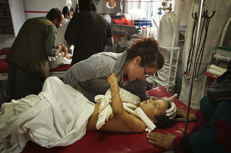 At a hospital in Kabul, nurse Georgia Novello comforts a child who was wounded in an airstrike that hit a Doctors Without Borders hospital in Kunduz in northern Afghanistan. 