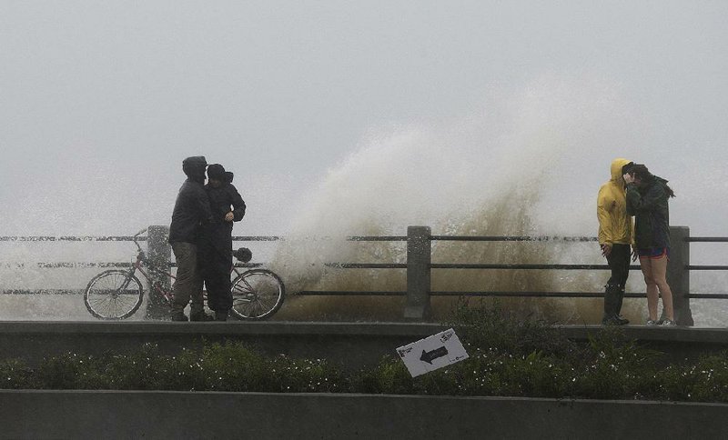 Waves churned by Hurricane Joaquin crash over a walkway Saturday in Charleston, S.C. Though spared the full brunt of the storm, parts of the East Coast were hit by record-setting rain, and President Barack Obama declared a state of emergency for South Carolina. 