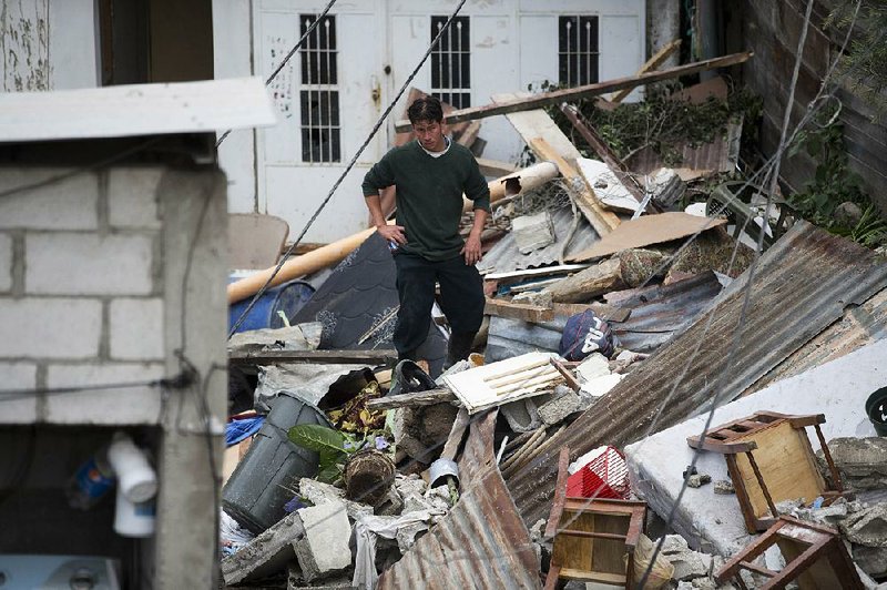 A man surveys the mudslide damage to homes Saturday in Cambray, a neighborhood in Santa Catarina Pinula outside Guatemala City. 