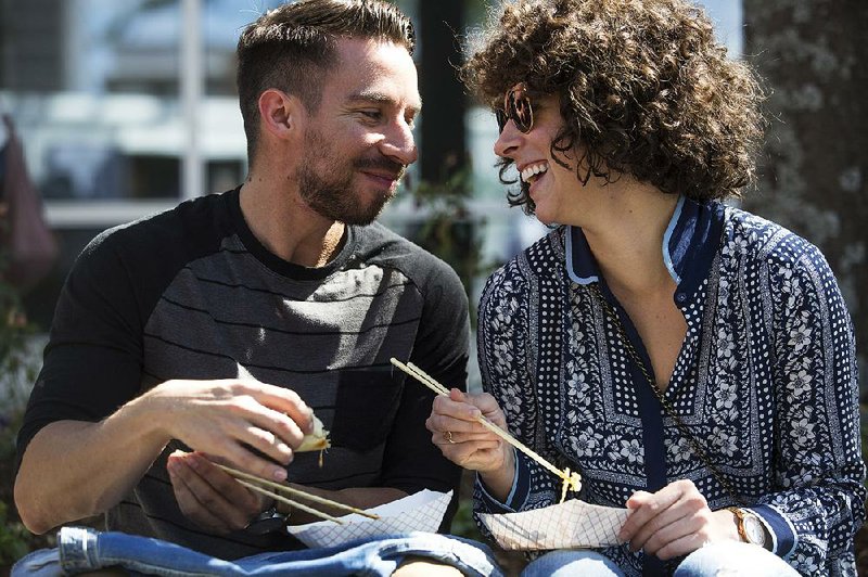 Pablo Sanchez and Katie Young enjoy a meal from Southern Gourmasian during Saturday’s Main Street Food Truck Festival in Little Rock. It was the pair’s first visit to the festival. More photos are available at arkansasonline.com/galleries. 