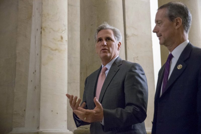 In this Sept. 30, 2015 file photo, House Majority Leader Kevin McCarthy of Calif., left, walks  on Capitol Hill in Washington. 