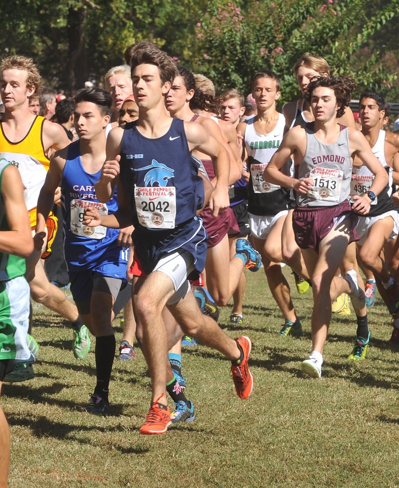 T.J. Sugg, Springdale Har-Ber cross country runner, works his way up in the pack Saturday as he competes in the high school boys run at the 2015 Chile Pepper Cross Country Festival in Fayetteville. Sugg finished in eighth place for the boys division.
